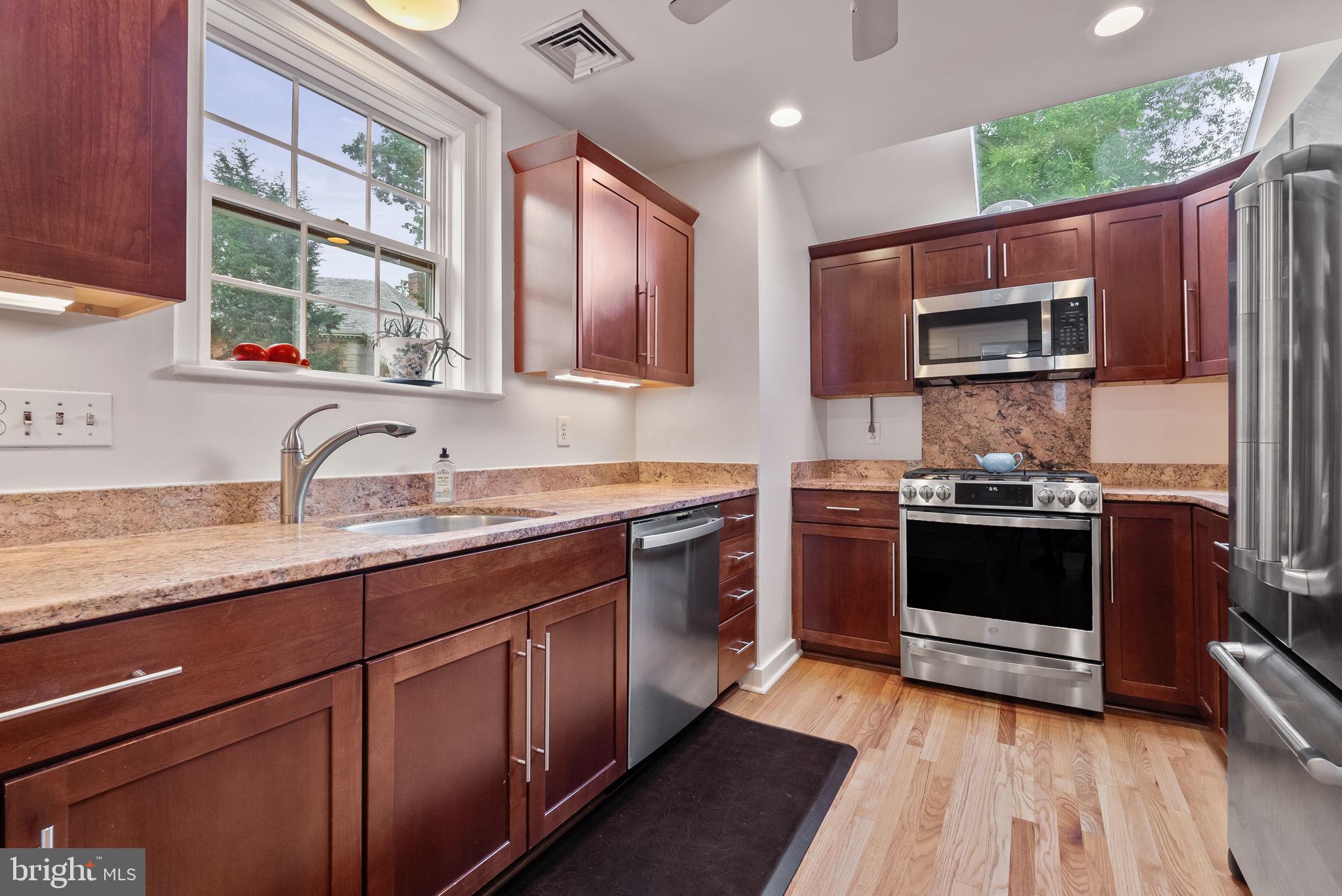1703 Russell Road Alexandria, VA 22301 - Photo 21 of 42 a kitchen with stainless steel appliances granite countertop a stove a sink and a microwave