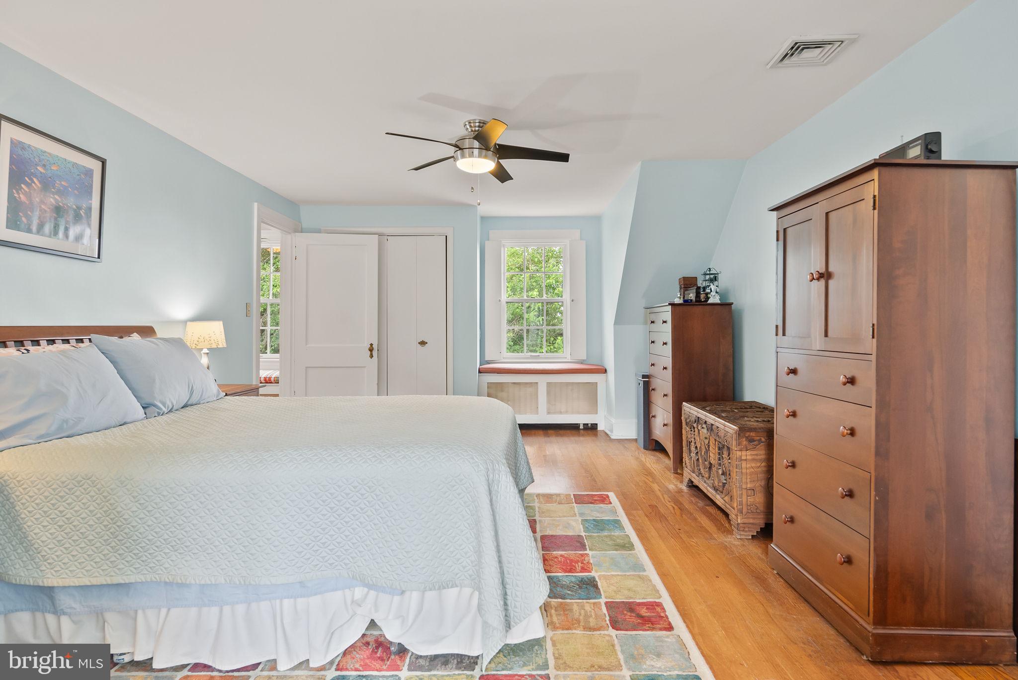 1703 Russell Road Alexandria, VA 22301 - Photo 25 of 42 a spacious bedroom with a bed and dresser with mirror