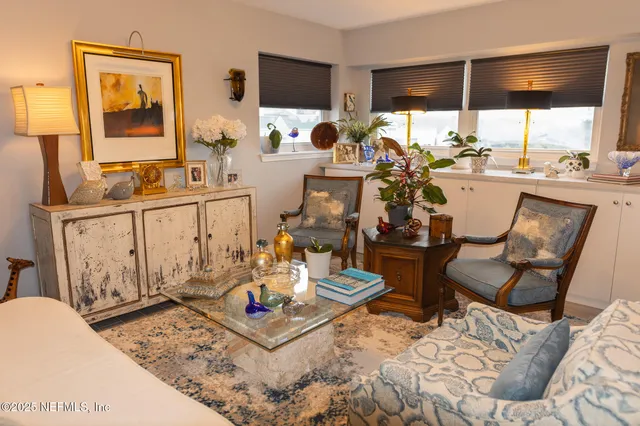 a living room with furniture and a floor to ceiling window