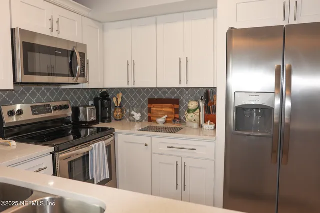 a bathroom with a sink vanity and toilet