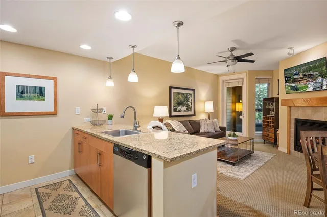 a view of living room with granite countertop furniture and fireplace