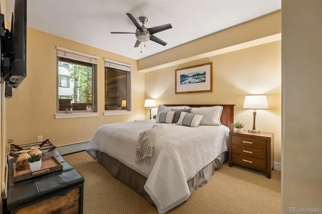 a spacious bedroom with a bed and a window