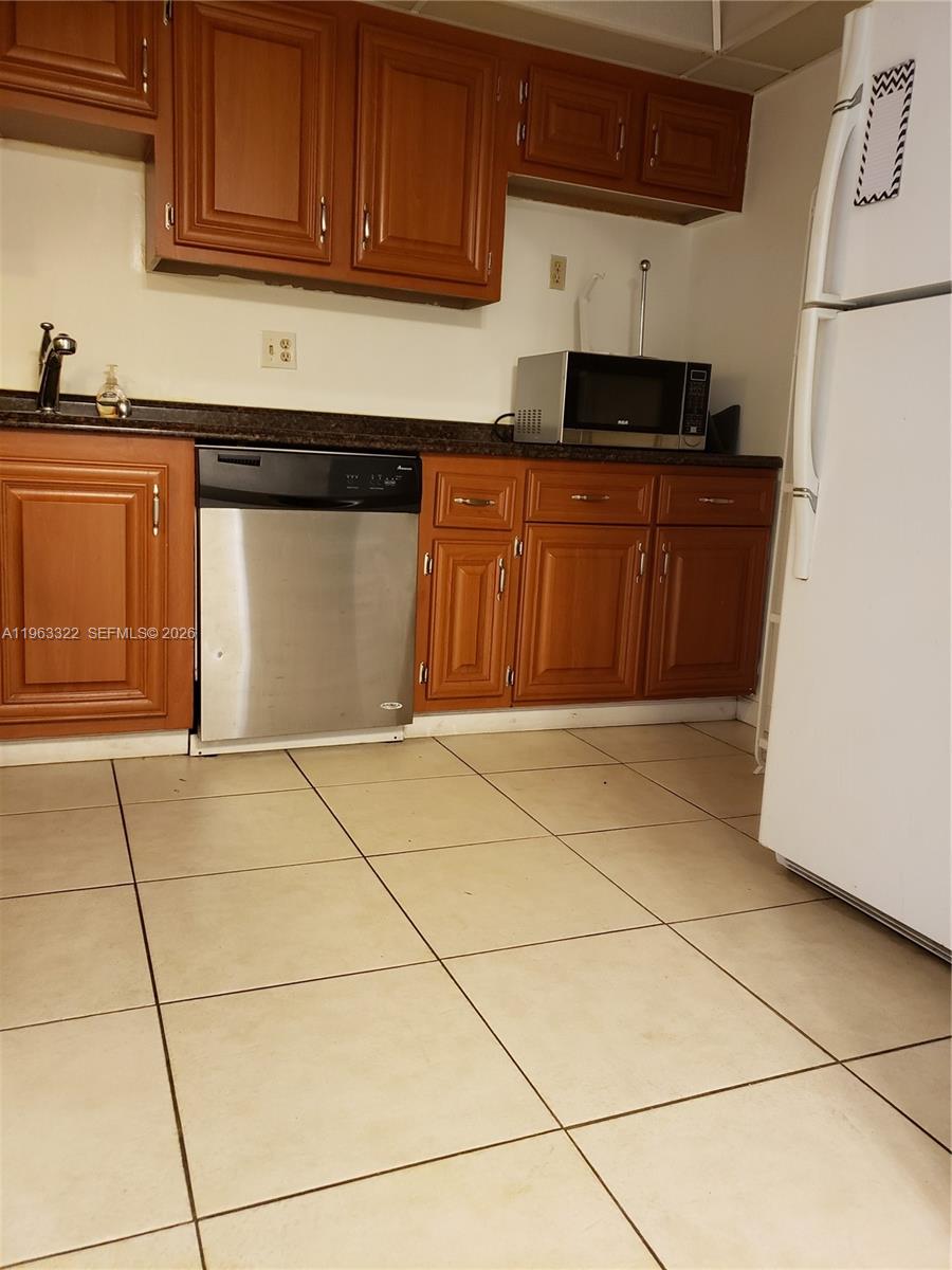 4170 Inverrary Drive, Unit 310 Lauderhill, FL 33319 - Photo 3 of 10 a kitchen with stainless steel appliances granite countertop a stove a refrigerator and a sink