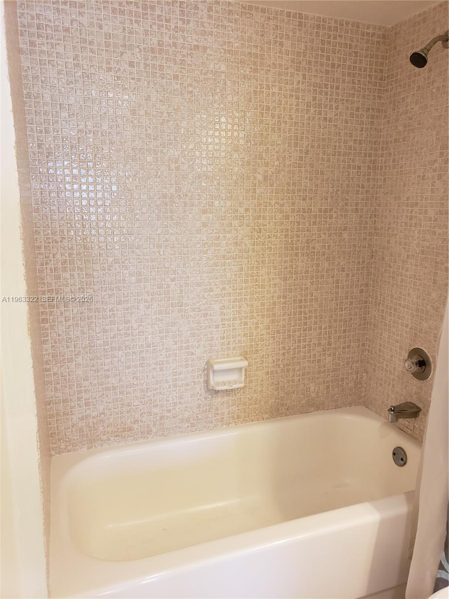4170 Inverrary Drive, Unit 310 Lauderhill, FL 33319 - Photo 8 of 10 a bathroom with a bathtub