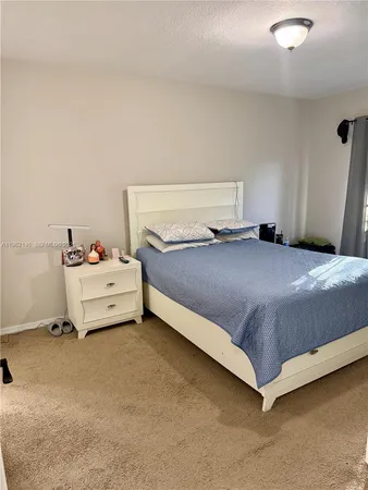 a bathroom with a sink a toilet a mirror and shower curtain