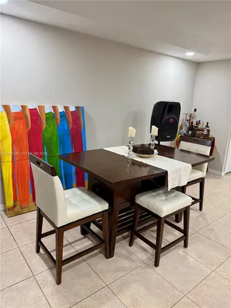 a kitchen with stainless steel appliances granite countertop a refrigerator a stove and a sink with wooden cabinets