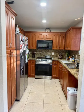 a view of a hallway with an empty space and a livingroom