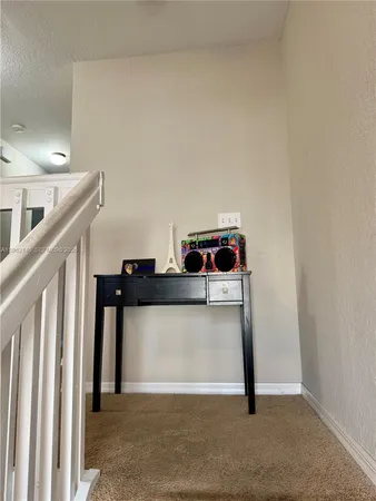 a view of a hallway with washer and dryer