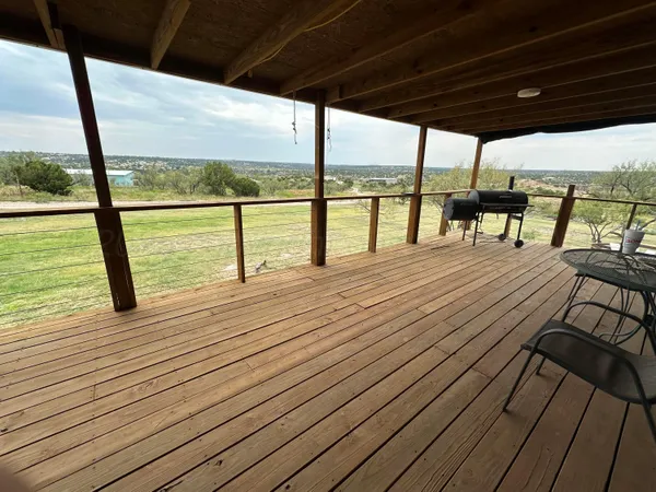 a view of porch with wooden floor