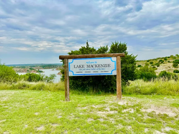 a sign on the side of the river