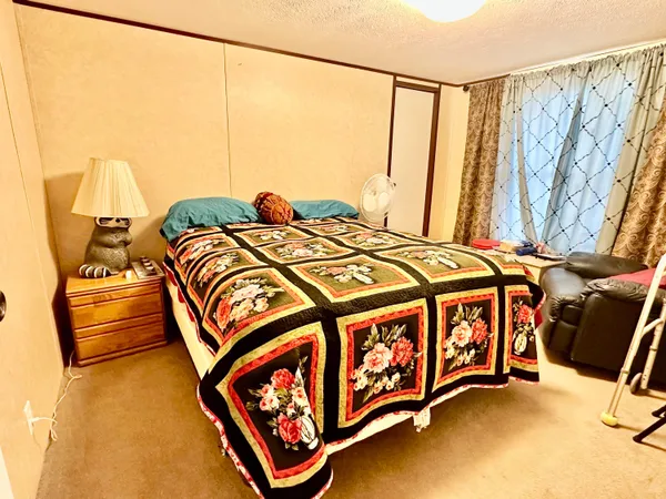 a bed sitting in a bedroom next to a window