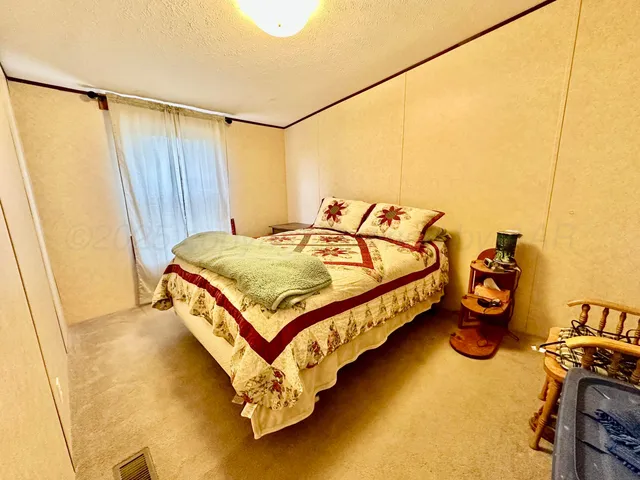 a bedroom with a bed and a table