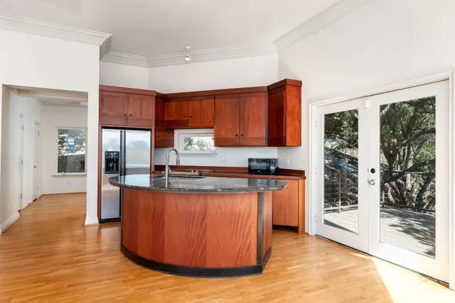 a view of a kitchen with a sink and a fireplace