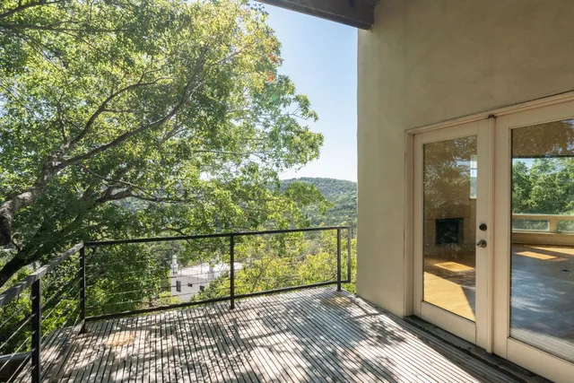 a kitchen with stainless steel appliances granite countertop a stove a refrigerator a sink dishwasher and wooden cabinets with wooden floor