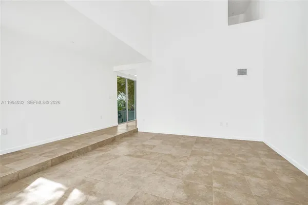 a large kitchen with stainless steel appliances granite countertop a stove refrigerator and a sink