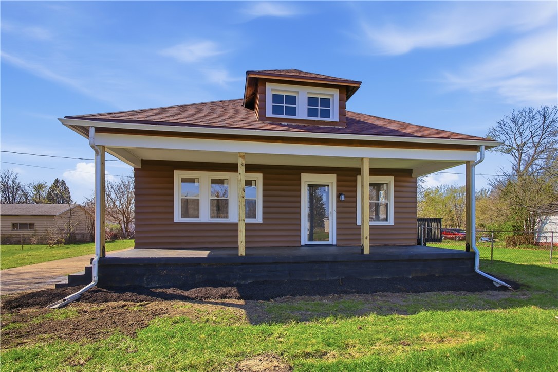 This charming residence features a welcoming front porch and a distinctive dormer, perfect for comfortable living.
