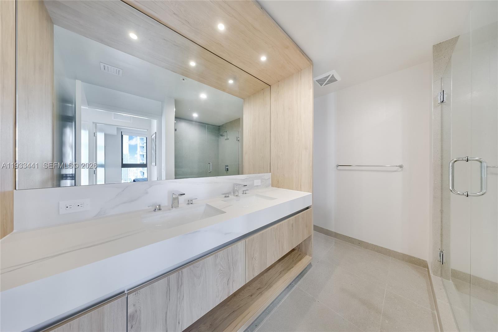11 Northeast 6th Street, Unit 3209 Miami, FL 33132 - Photo 12 of 27 a spacious bathroom with a tub sink and mirror