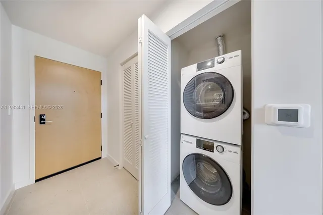 a view of a hallway with washer and dryer