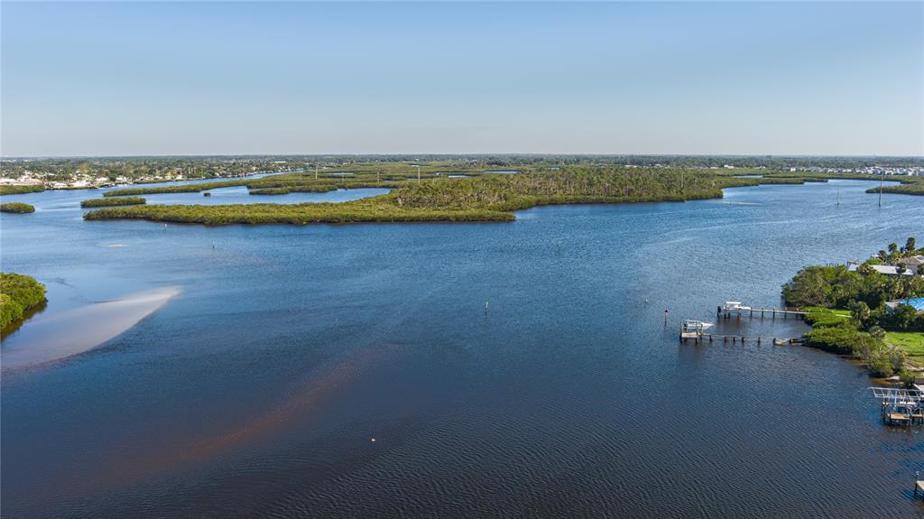703 Tropical Drive Bradenton, FL 34208 - Photo 1 of 1 an aerial view of a house with a garden and lake view