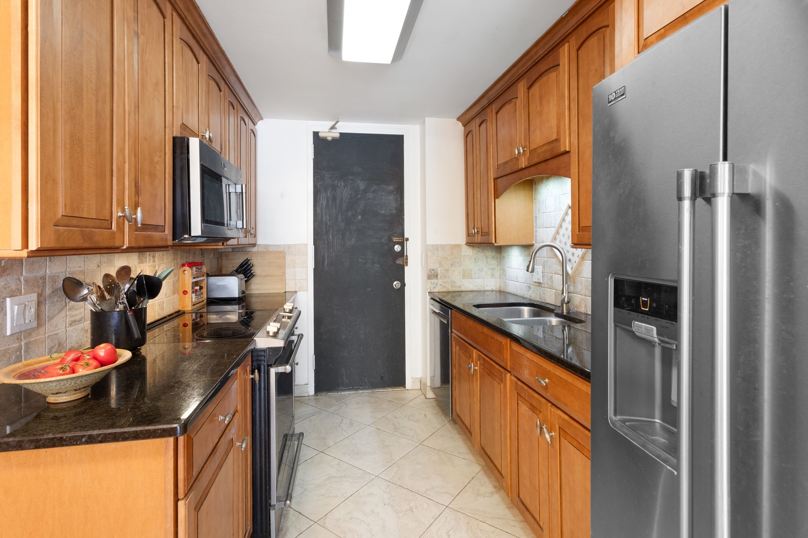 5901 North Sheridan Road, Unit 2K Chicago, IL 60660 - Photo 11 of 27 a kitchen with a sink stove and refrigerator