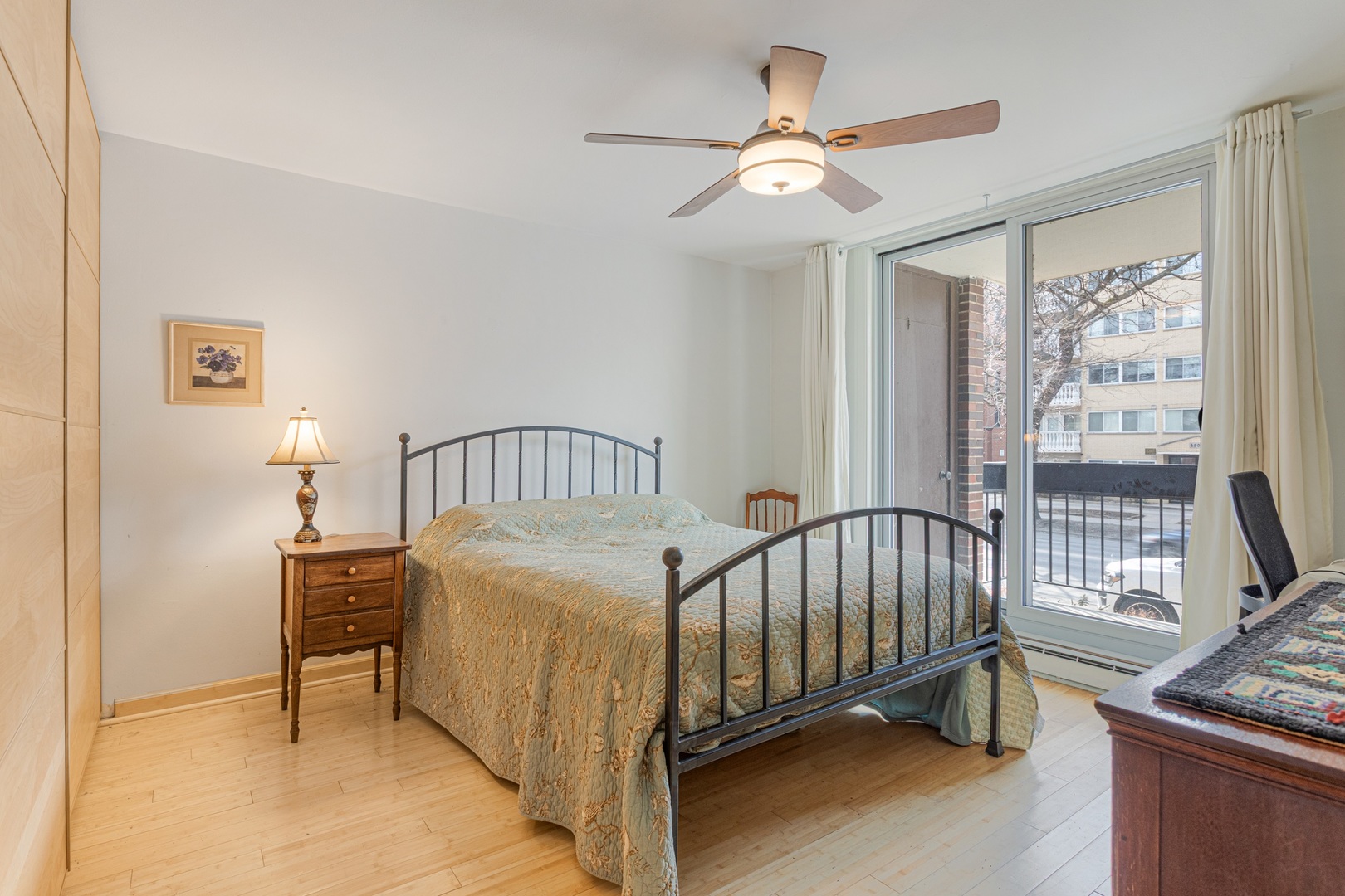 5901 North Sheridan Road, Unit 2K Chicago, IL 60660 - Photo 12 of 27 a bedroom with a bed and a chandelier