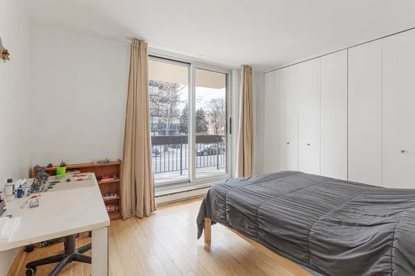 a bedroom with a bed and a table in it