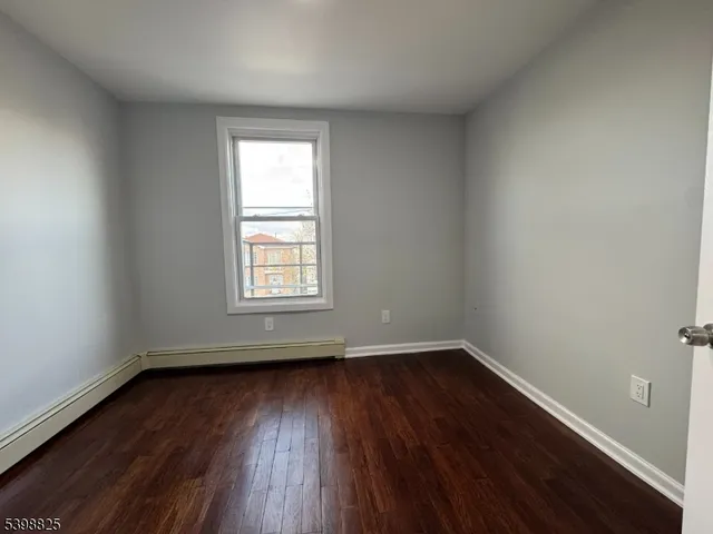 wooden floor and window in an empty room