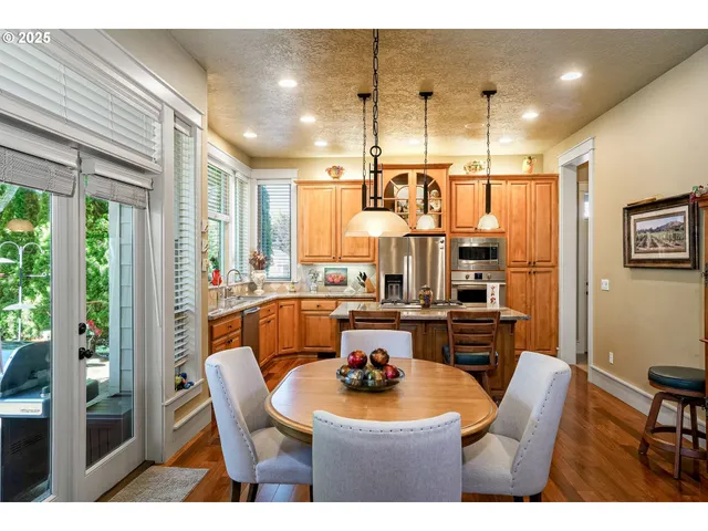a dining table chair next to a window