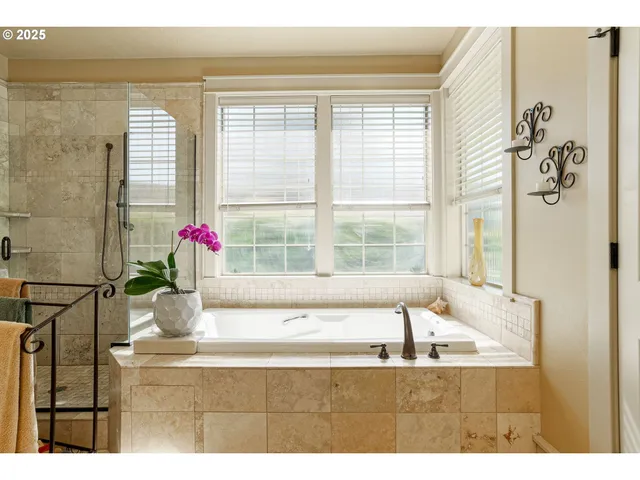 a view of a bathroom with a tub shower and window