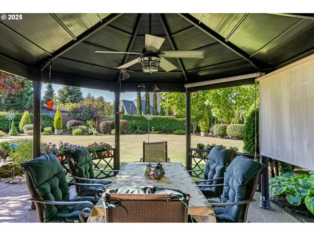 a view of a patio with table and chairs and potted plants