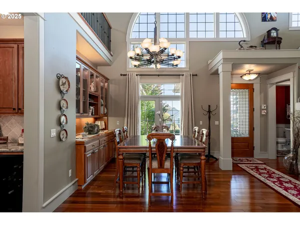 a view of a dining room with furniture and chandelier