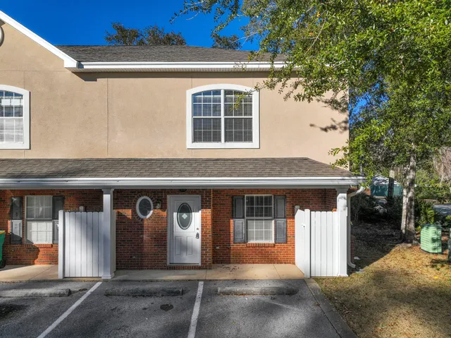 a front view of a house with large windows