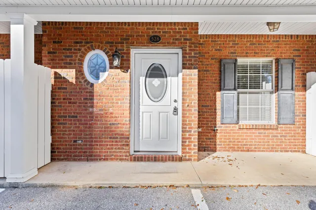 a front view of a house with many windows