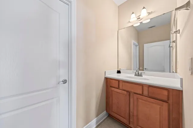 a bathroom with a double vanity sink and a mirror