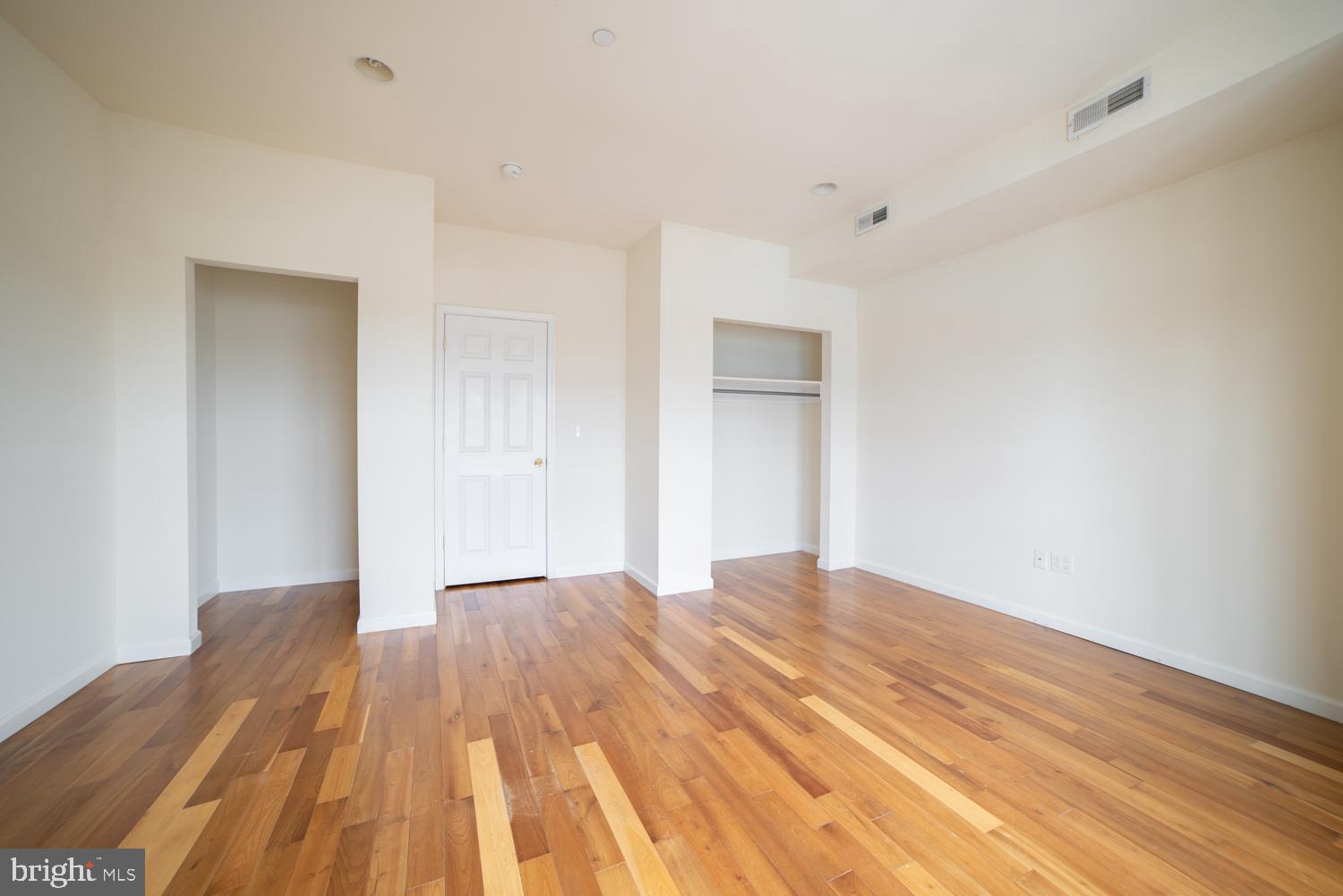 1830 North 16th Street, Unit 2 Philadelphia, PA 19121 - Photo 11 of 19 a bedroom with a bed and a wooden floor