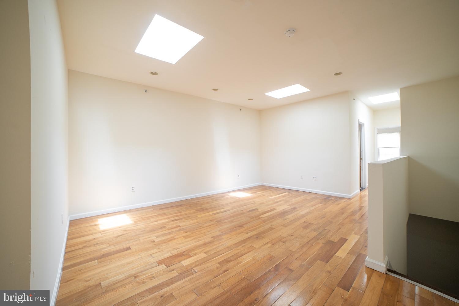 1830 North 16th Street, Unit 2 Philadelphia, PA 19121 - Photo 12 of 19 a view of an empty room with wooden floor and a window