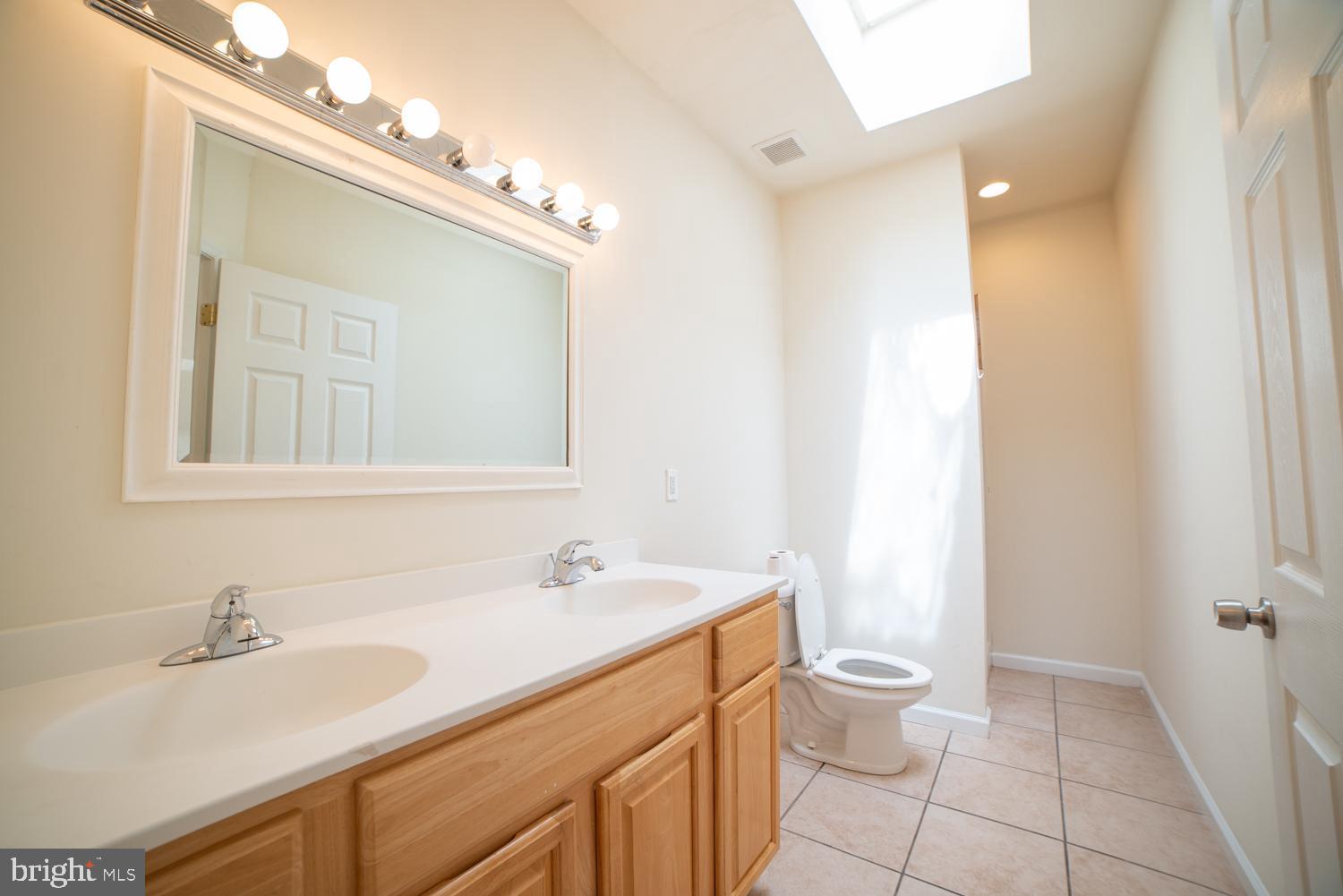 1830 North 16th Street, Unit 2 Philadelphia, PA 19121 - Photo 13 of 19 a bathroom with a sink a toilet and a mirror