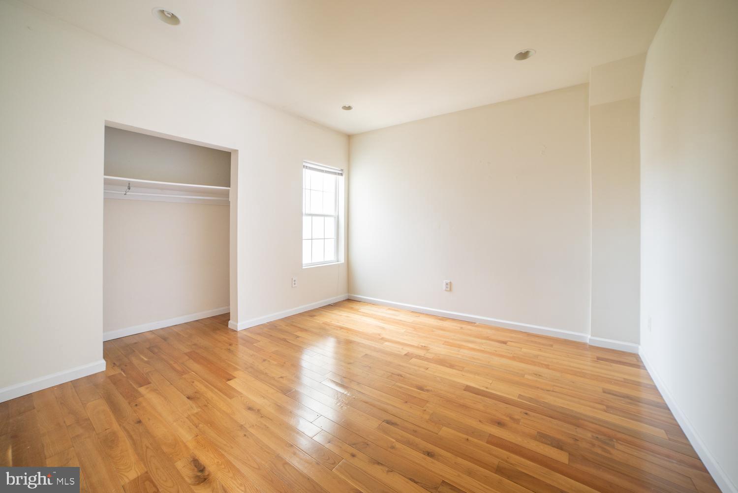 1830 North 16th Street, Unit 2 Philadelphia, PA 19121 - Photo 15 of 19 a view of an empty room with wooden floor and a window