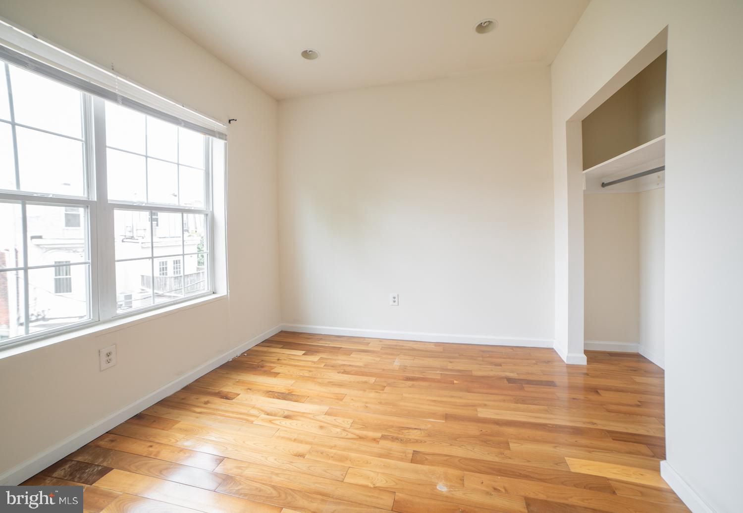 1830 North 16th Street, Unit 2 Philadelphia, PA 19121 - Photo 16 of 19 a view of an empty room with wooden floor and a window