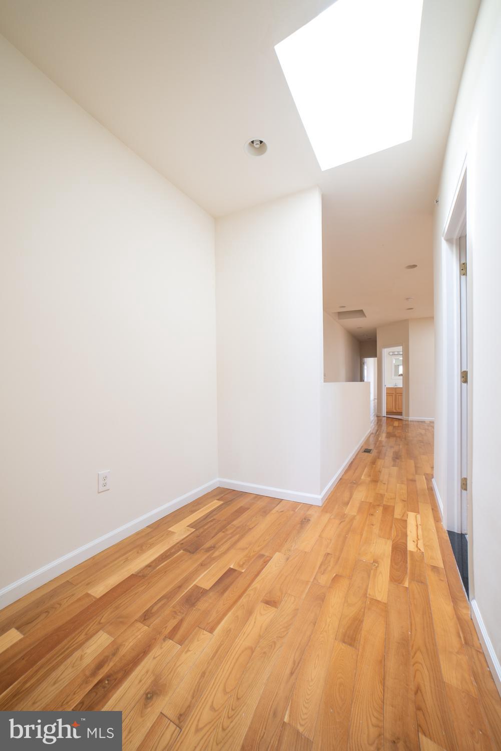 1830 North 16th Street, Unit 2 Philadelphia, PA 19121 - Photo 18 of 19 a view of a big room with wooden floor and a potted plant