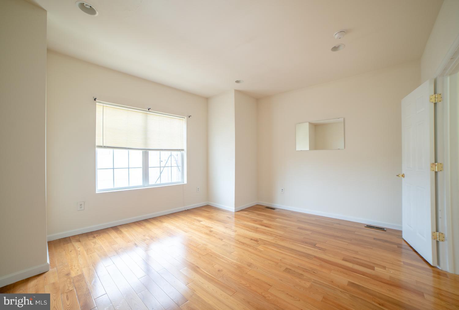 1830 North 16th Street, Unit 2 Philadelphia, PA 19121 - Photo 3 of 19 a view of an empty room with wooden floor and a window