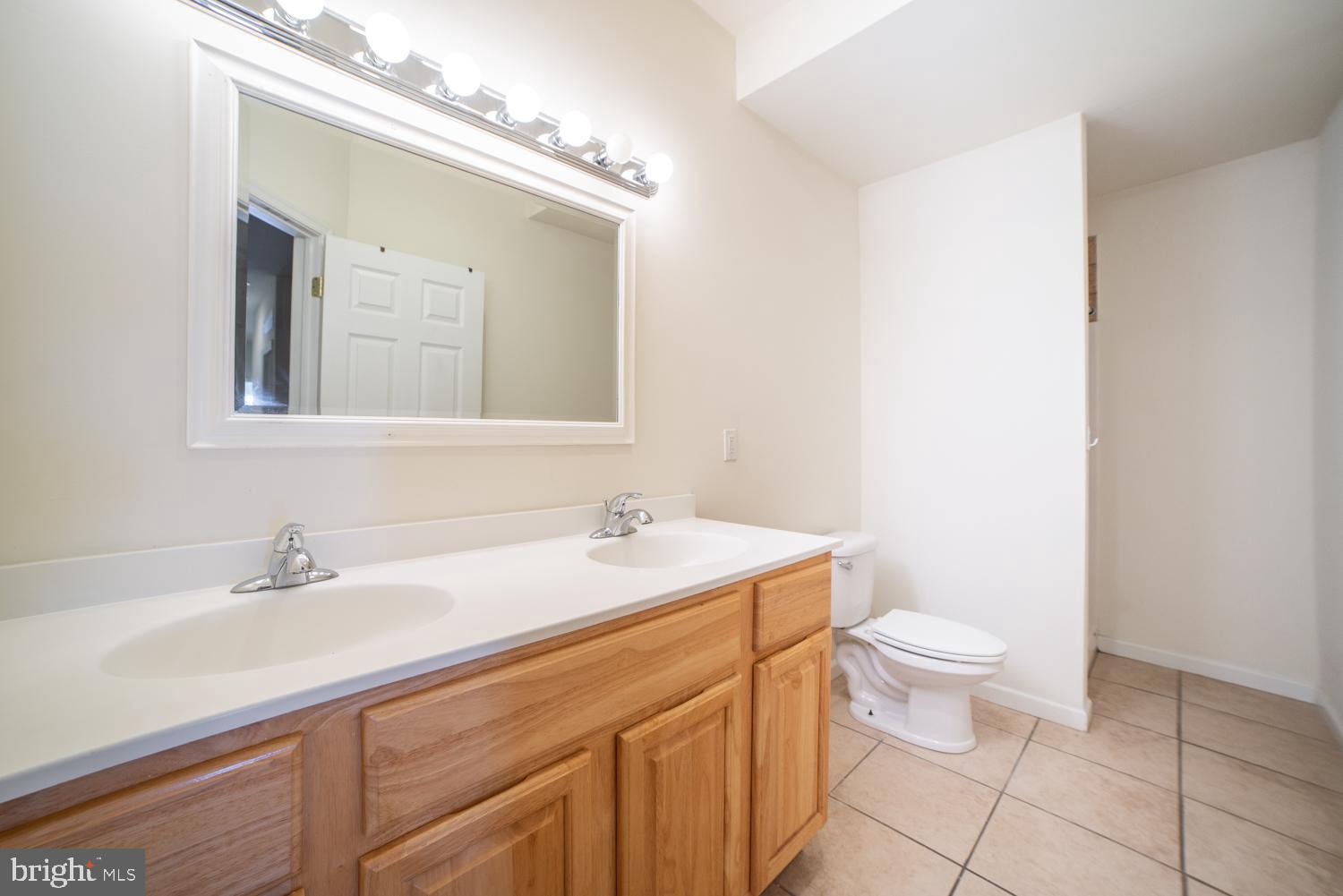 1830 North 16th Street, Unit 2 Philadelphia, PA 19121 - Photo 6 of 19 a bathroom with a sink a toilet and mirror