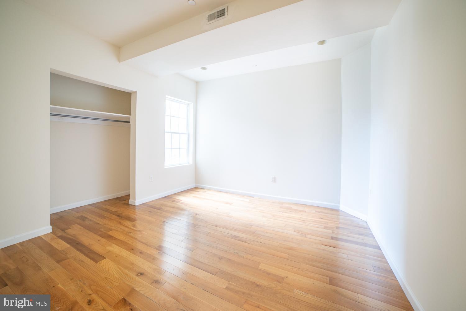 1830 North 16th Street, Unit 2 Philadelphia, PA 19121 - Photo 7 of 19 a view of an empty room with wooden floor and a window