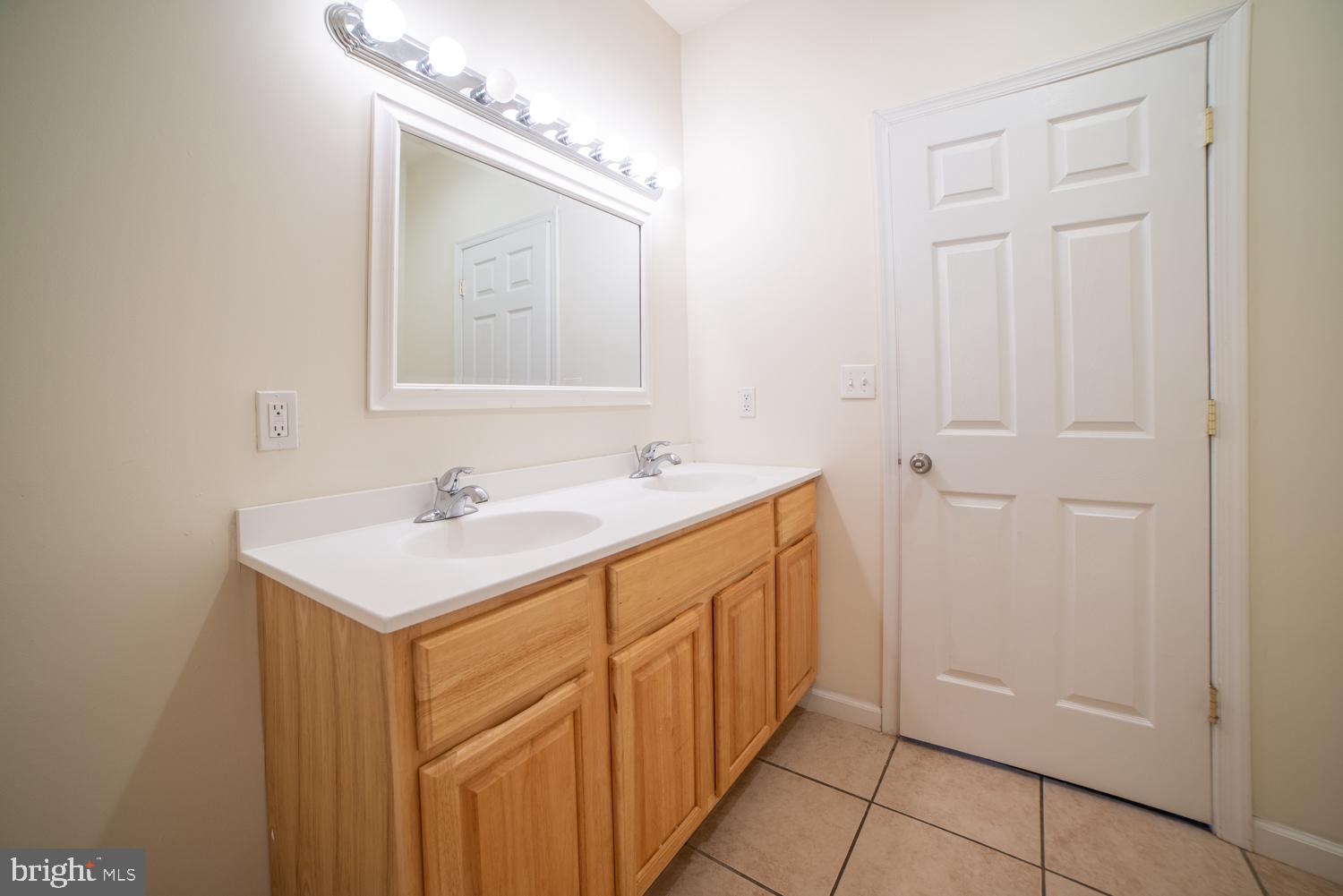 1830 North 16th Street, Unit 2 Philadelphia, PA 19121 - Photo 10 of 19 a bathroom with a sink a mirror and a vanity