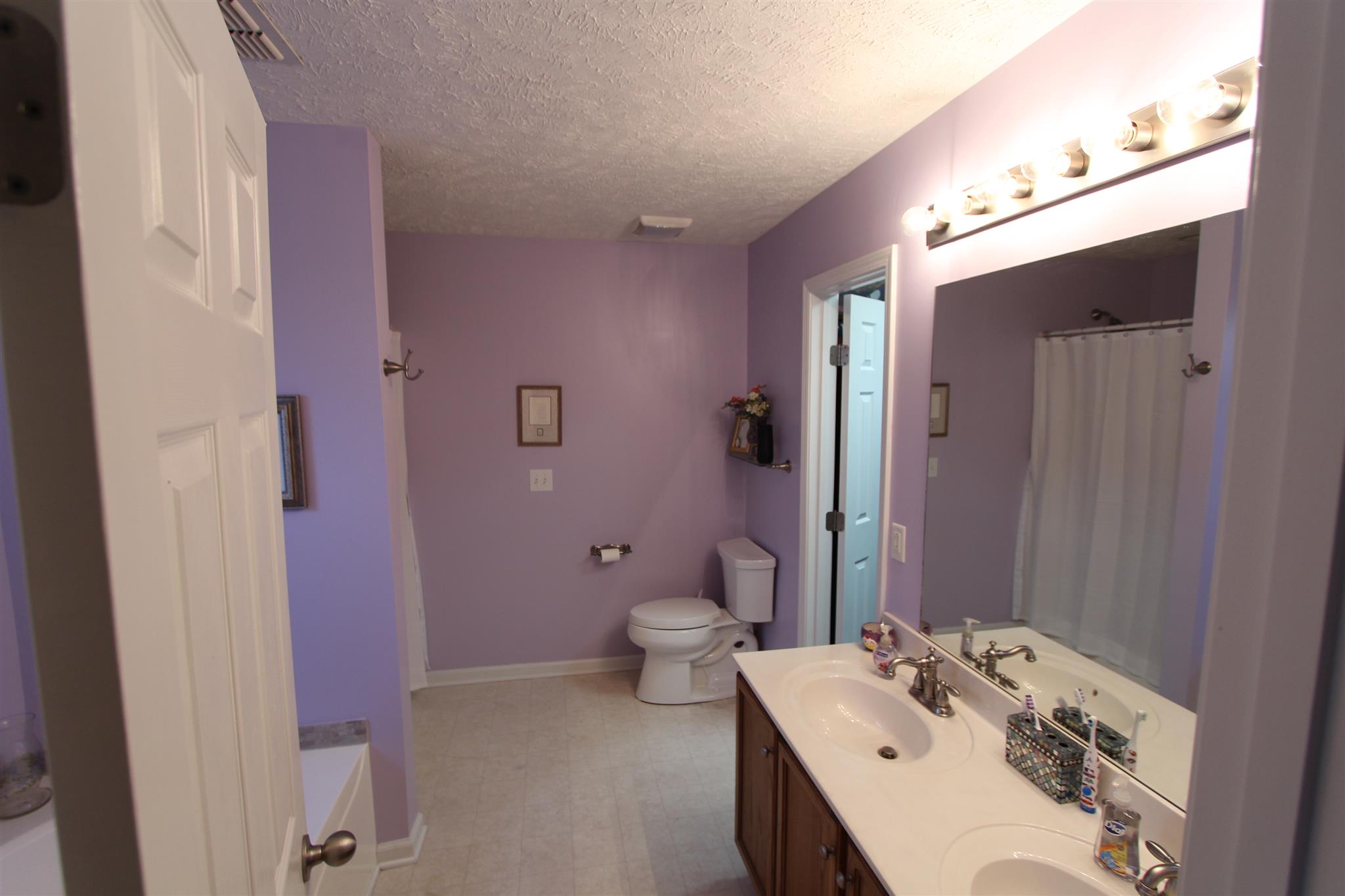 677 Crescent Road Murfreesboro, TN 37128 - Photo 9 of 15 a bathroom with a double vanity sink toilet and mirror
