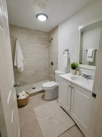 a bathroom with a sink toilet and shower
