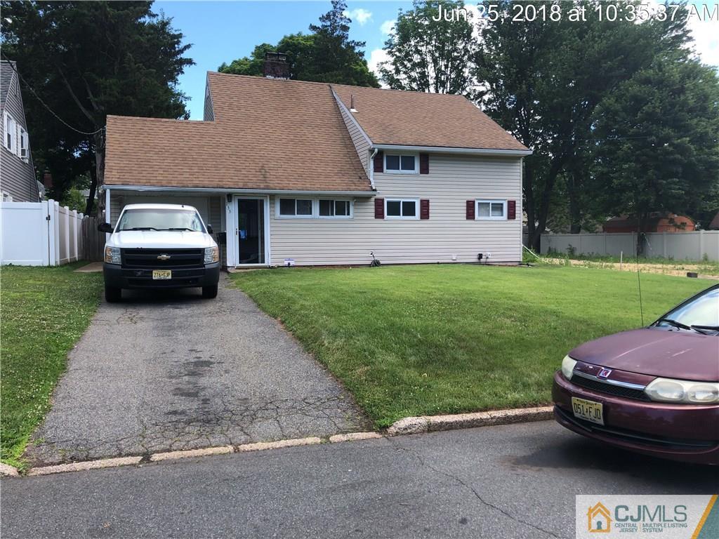 133 Ridge Road Colonia, NJ 07067 - Photo 1 of 5 a car parked in front of a house with a yard