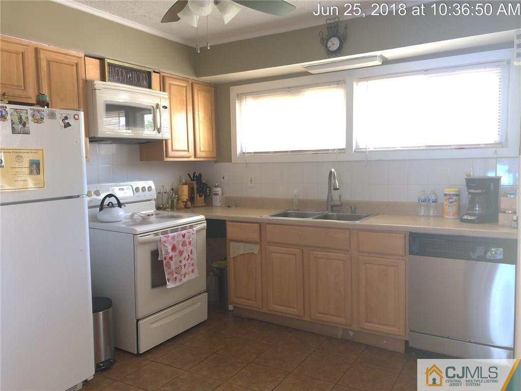 133 Ridge Road Colonia, NJ 07067 - Photo 2 of 5 a utility room with cabinets dryer and washer