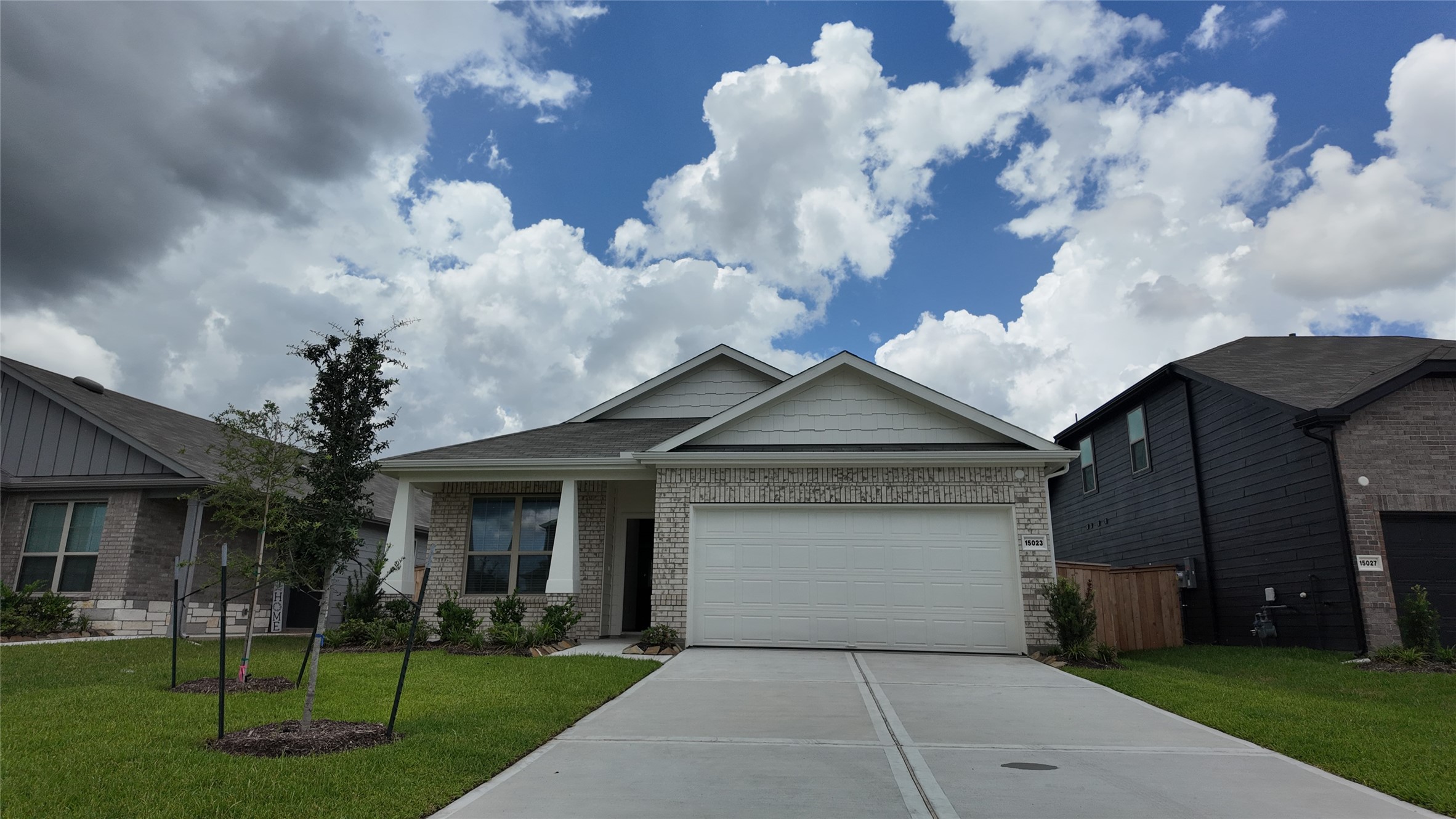15023 Rustic Moon Road Conroe, TX 77302 - Photo 1 of 18 a front view of a house with a yard and garage