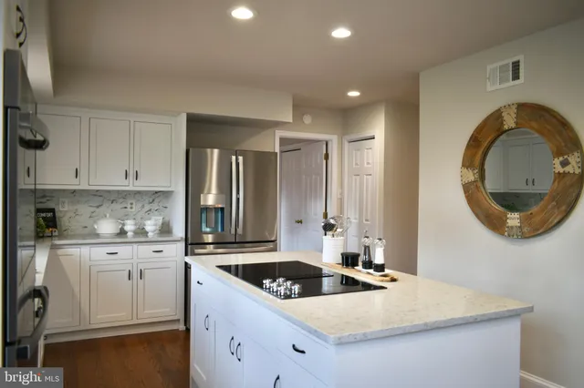 a kitchen that has a sink a stove and cabinets